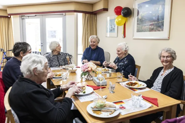 Maggie Beer having a meal with senior citizens